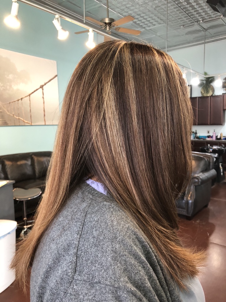 Caramel balayage styled straight, catching the light
